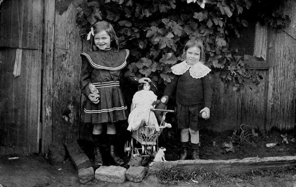 Mary and Patrick Tracey with their dolls and a toy pram, Cecil Plains, Queensland, 1900s, original